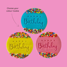 Load image into Gallery viewer, Three happy birthday cookies with blue, pink and yellow icing, decorated with sprinkles on a pinkbackground
