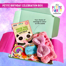 Load image into Gallery viewer, A small gift box floating on a sparkly pink and purple background with a sheet face mask, fluffy headband, handmade happy birthday cookie with blue icing and a rainbow sticker.
