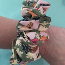 Load and play video in Gallery viewer, Handmade Scrunchie in Secret Garden, a olive green fabric with peach tone florals video
