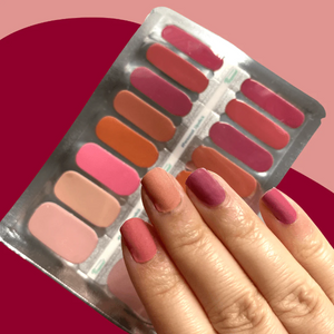 Nude to Red Lipstick shade nail wraps displayed on hand with packaging in the background