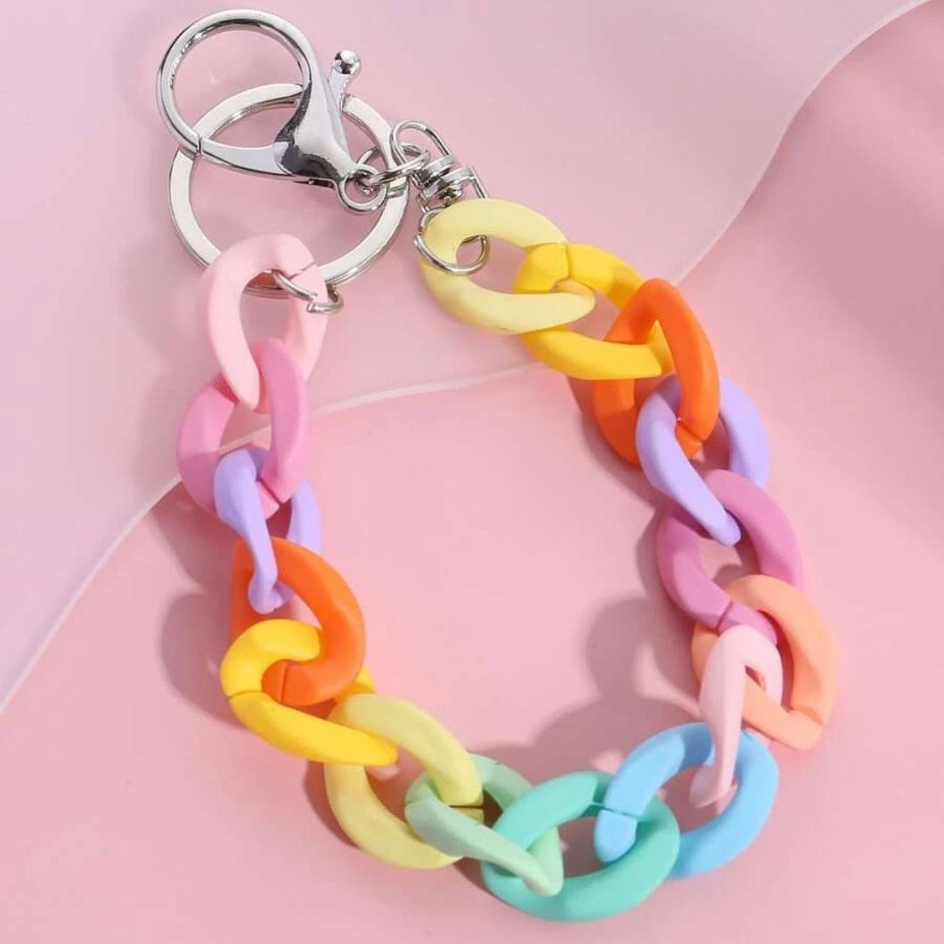 Rainbow coloured block wristlet keychain on pink background